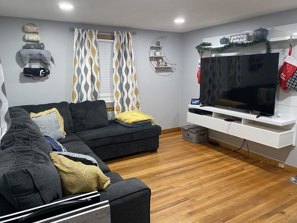 245 Edendale Street Springfield, MA 01104 - Photo 4 of 8 a living room with furniture and a flat screen tv
