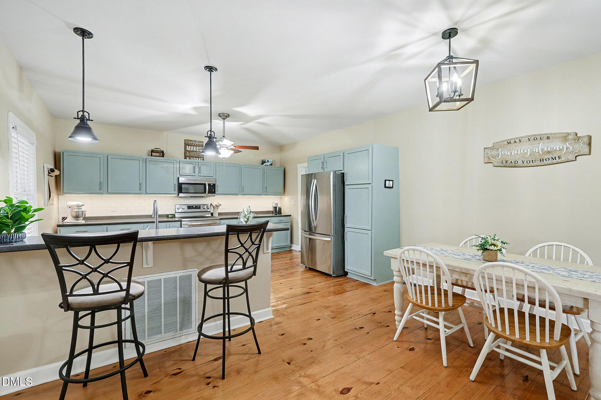 7228 Cleveland School Road Garner, NC 27529 - Photo 11 of 28 a view of a dining room with furniture wooden floor and chandelier