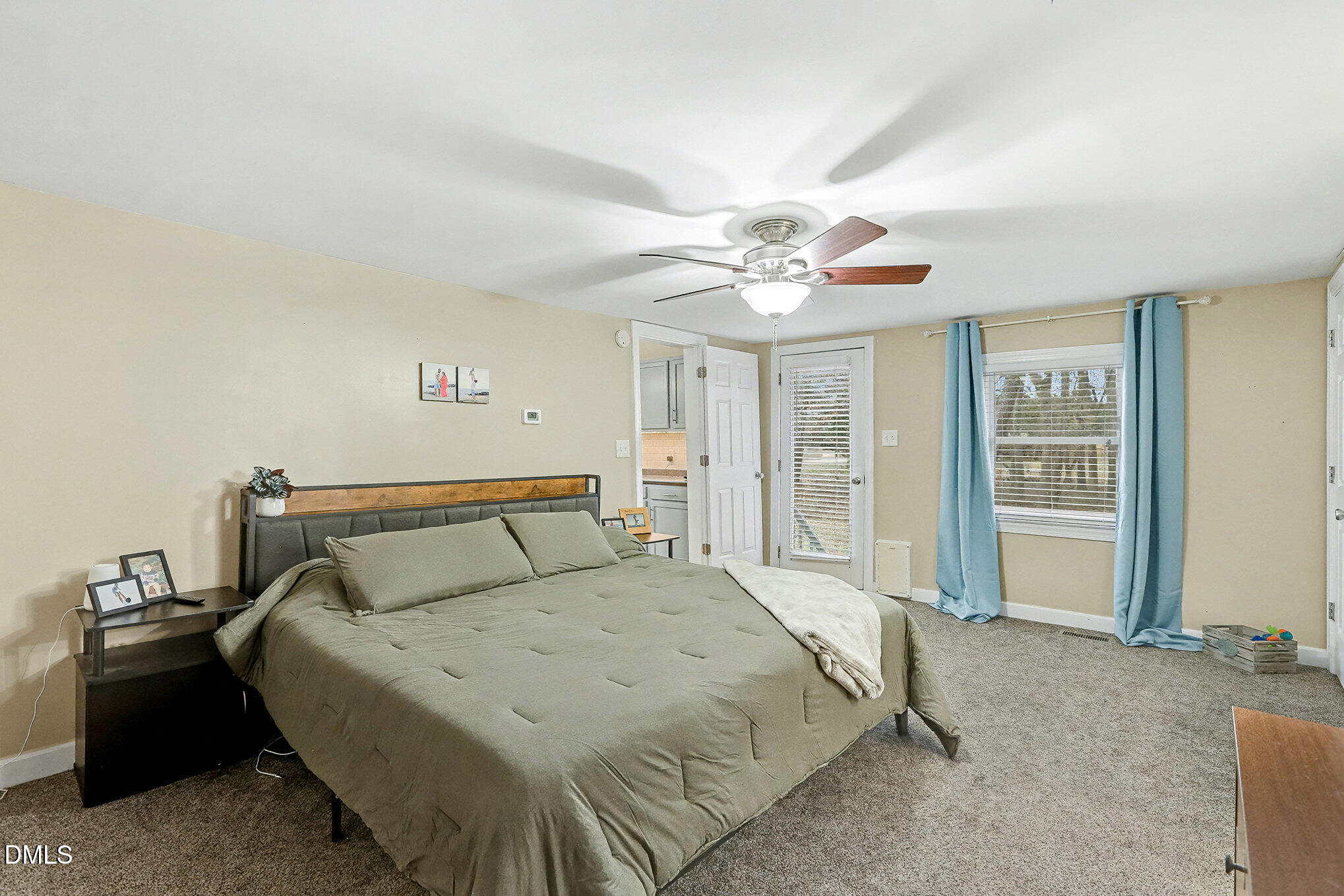 7228 Cleveland School Road Garner, NC 27529 - Photo 18 of 28 a bedroom with a large bed and a chandelier