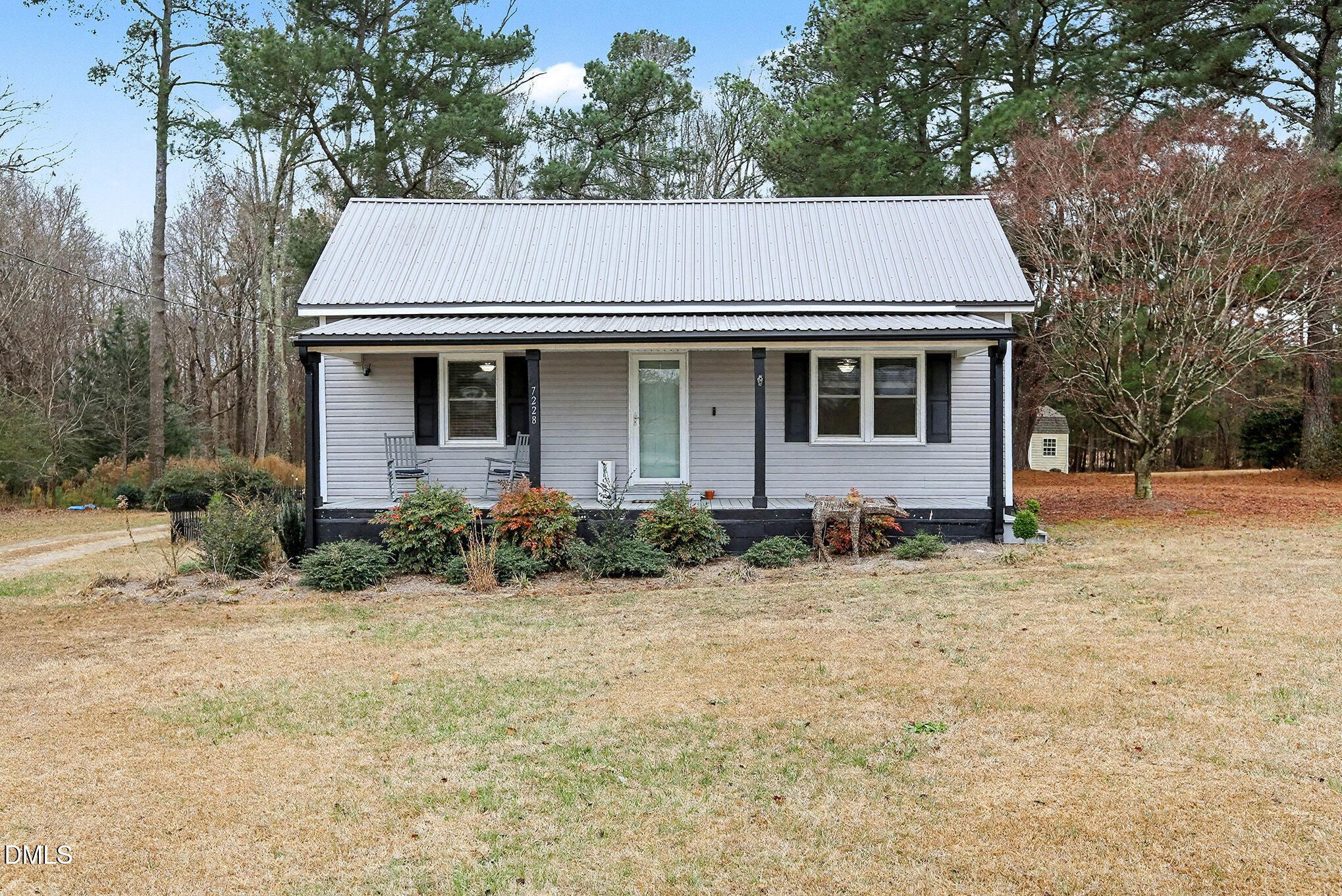 7228 Cleveland School Road Garner, NC 27529 - Photo 2 of 28 a view of a white house with a yard and large tree