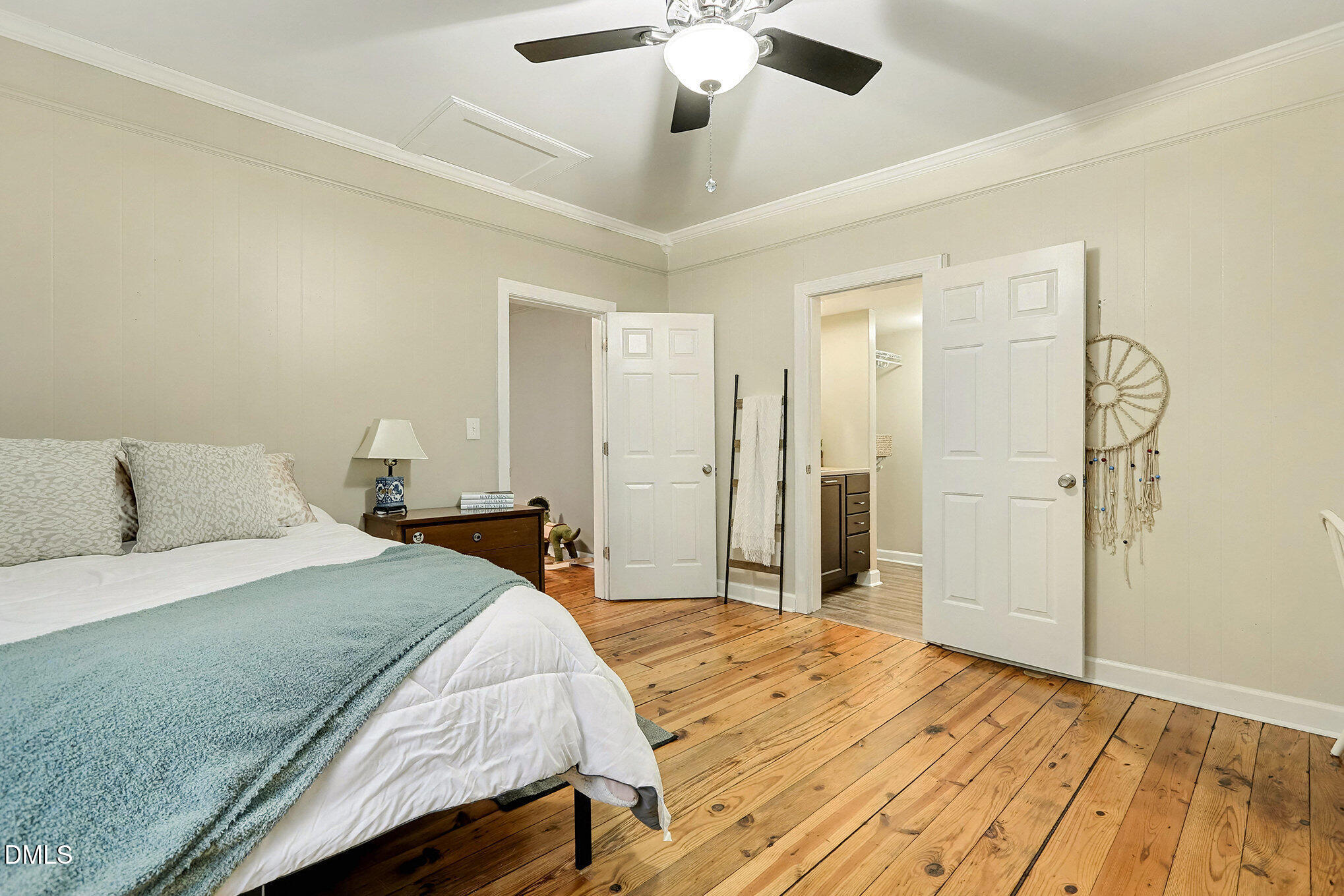 7228 Cleveland School Road Garner, NC 27529 - Photo 26 of 28 a bedroom with a large bed and a chandelier