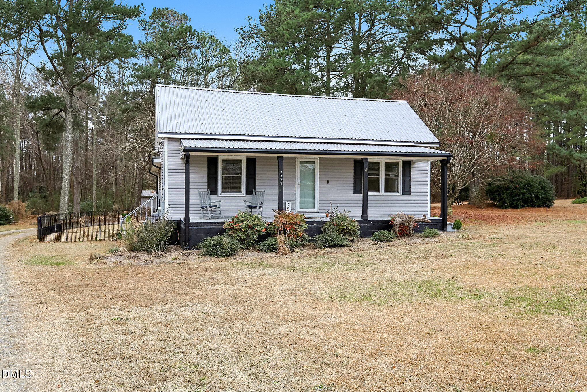 7228 Cleveland School Road Garner, NC 27529 - Photo 4 of 28 a backyard of a house with potted plants and large trees