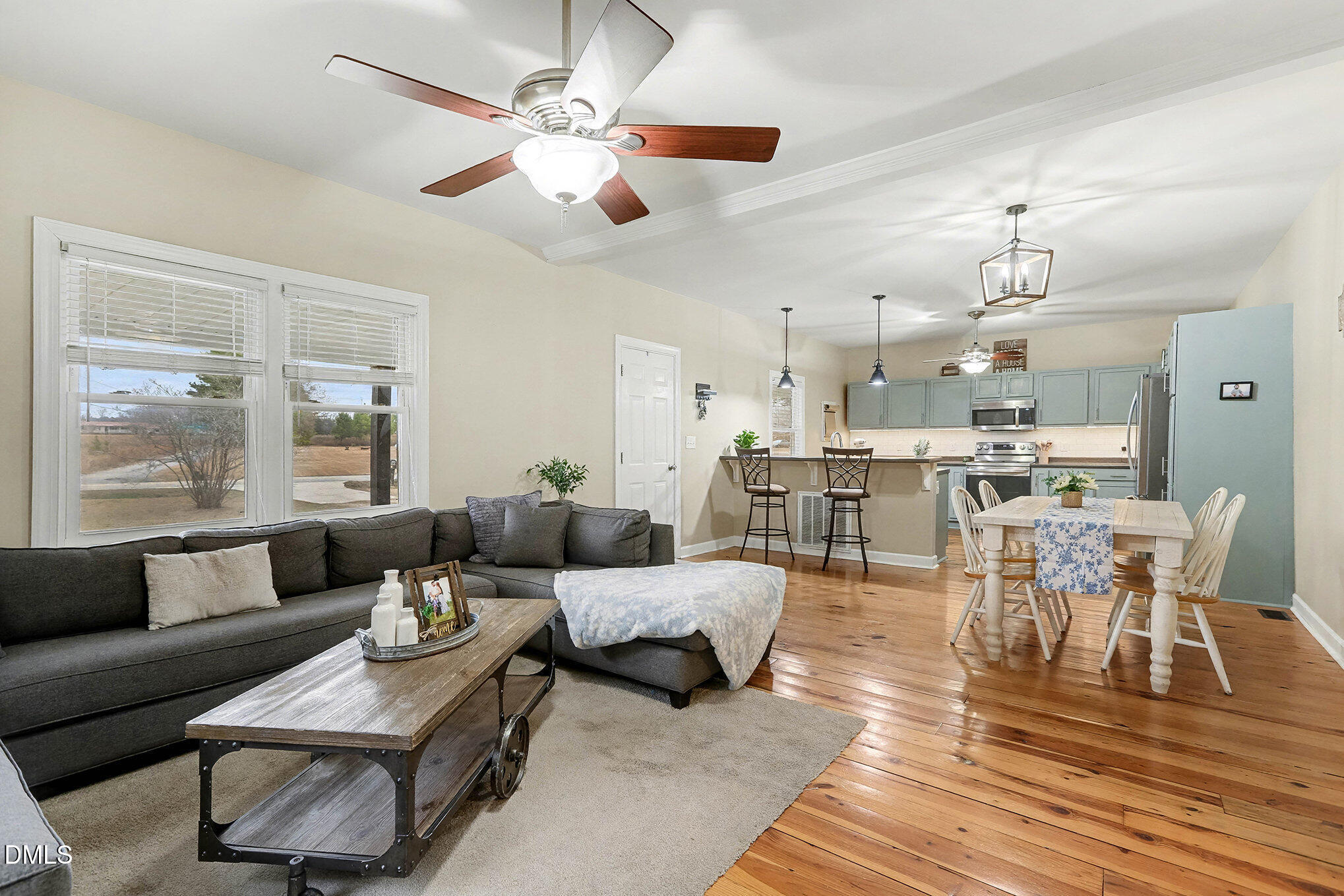 7228 Cleveland School Road Garner, NC 27529 - Photo 6 of 28 a living room with furniture kitchen view and a chandelier
