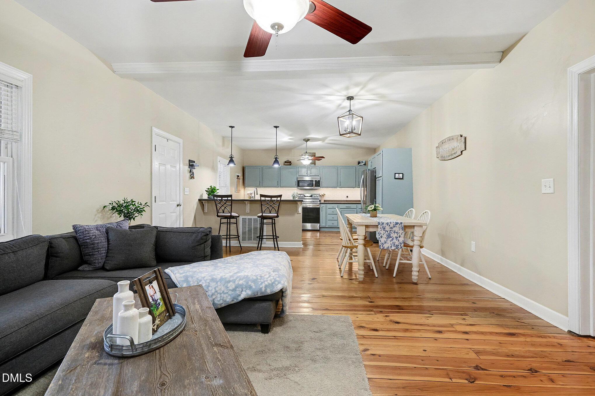 7228 Cleveland School Road Garner, NC 27529 - Photo 7 of 28 a living room with furniture kitchen view and a chandelier