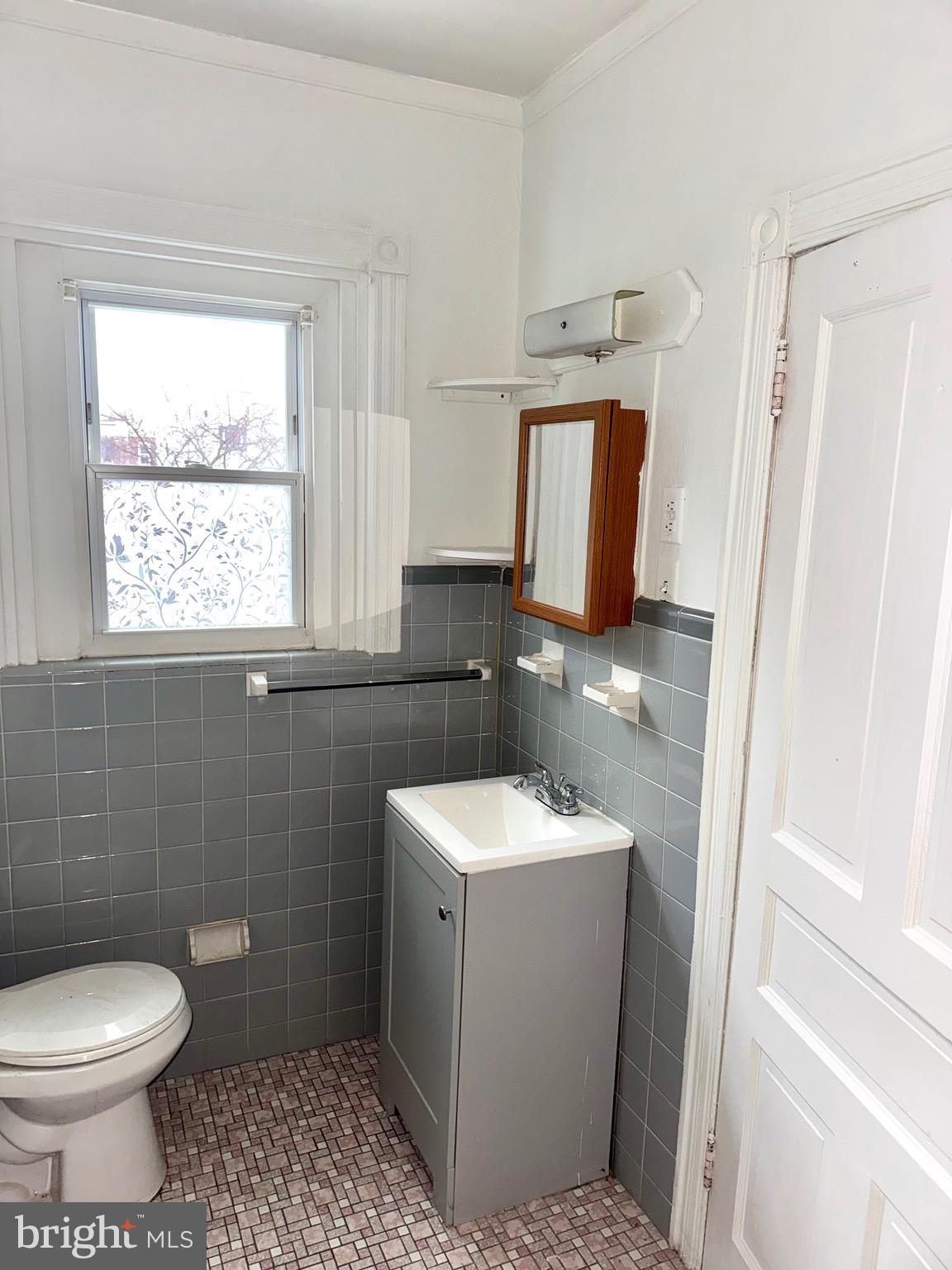 4515 Comly Street Philadelphia, PA 19135 - Photo 23 of 38 a bathroom with a sink toilet and mirror