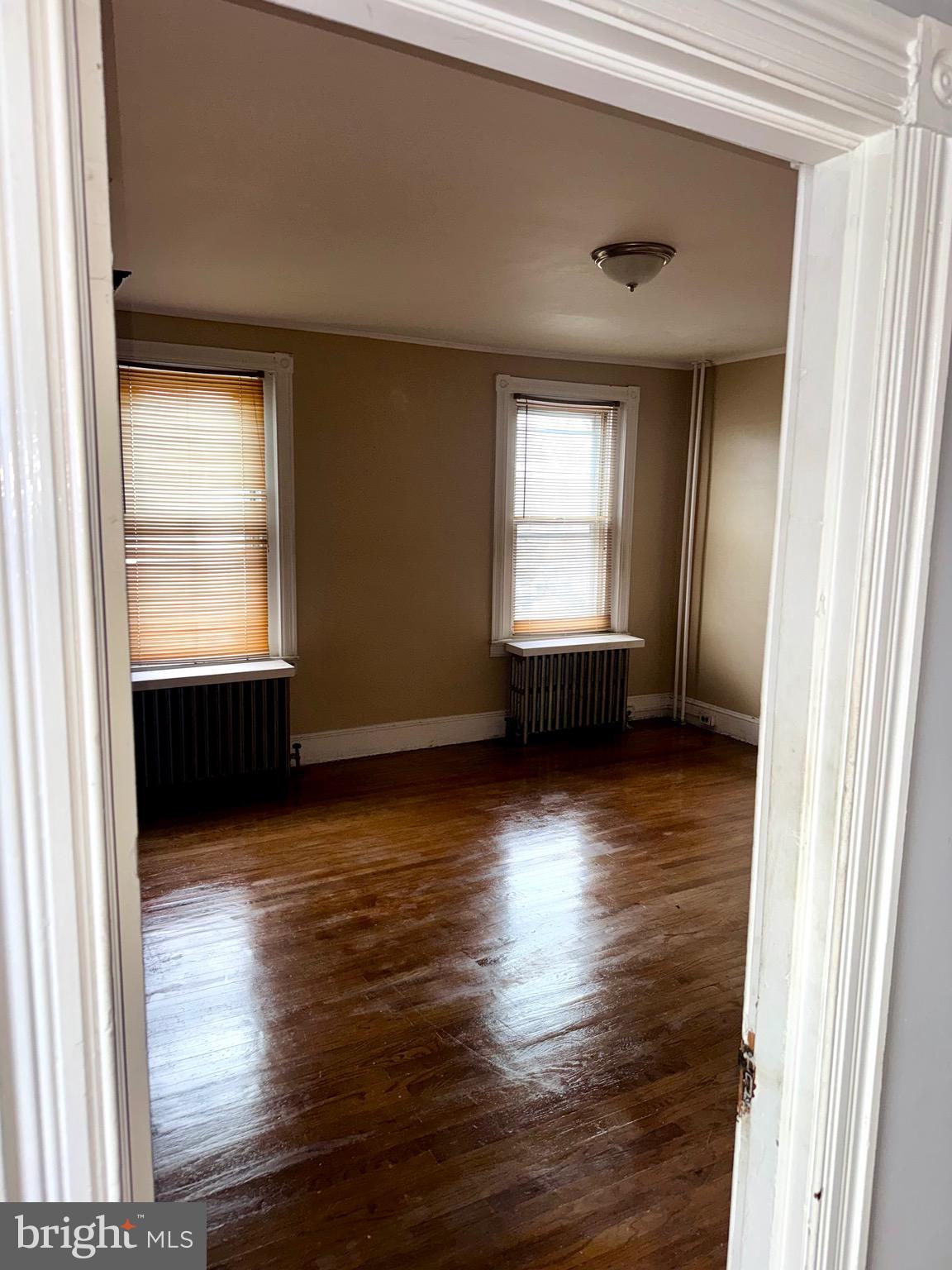 4515 Comly Street Philadelphia, PA 19135 - Photo 26 of 38 an empty room with wooden floor and windows
