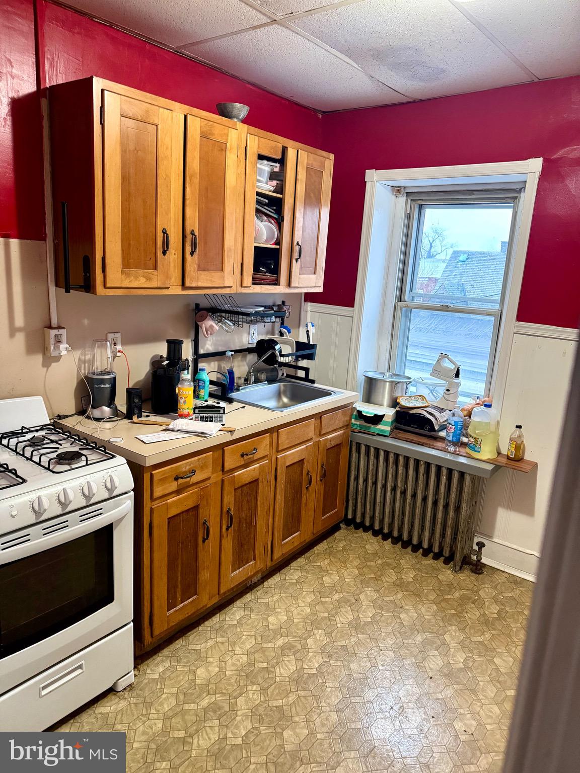 4515 Comly Street Philadelphia, PA 19135 - Photo 32 of 38 a kitchen with stainless steel appliances a stove a sink and a microwave