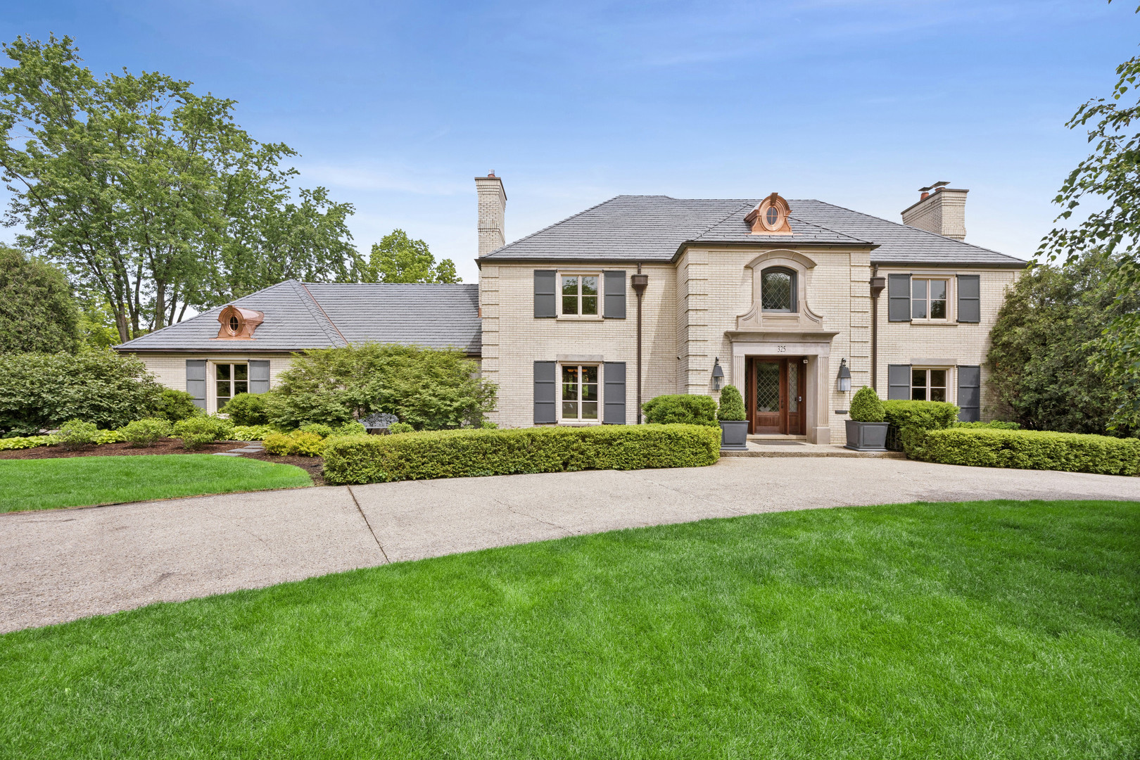325 Princeton Road Hinsdale, IL 60521 - Photo 1 of 55 a front view of a house with a garden and yard
