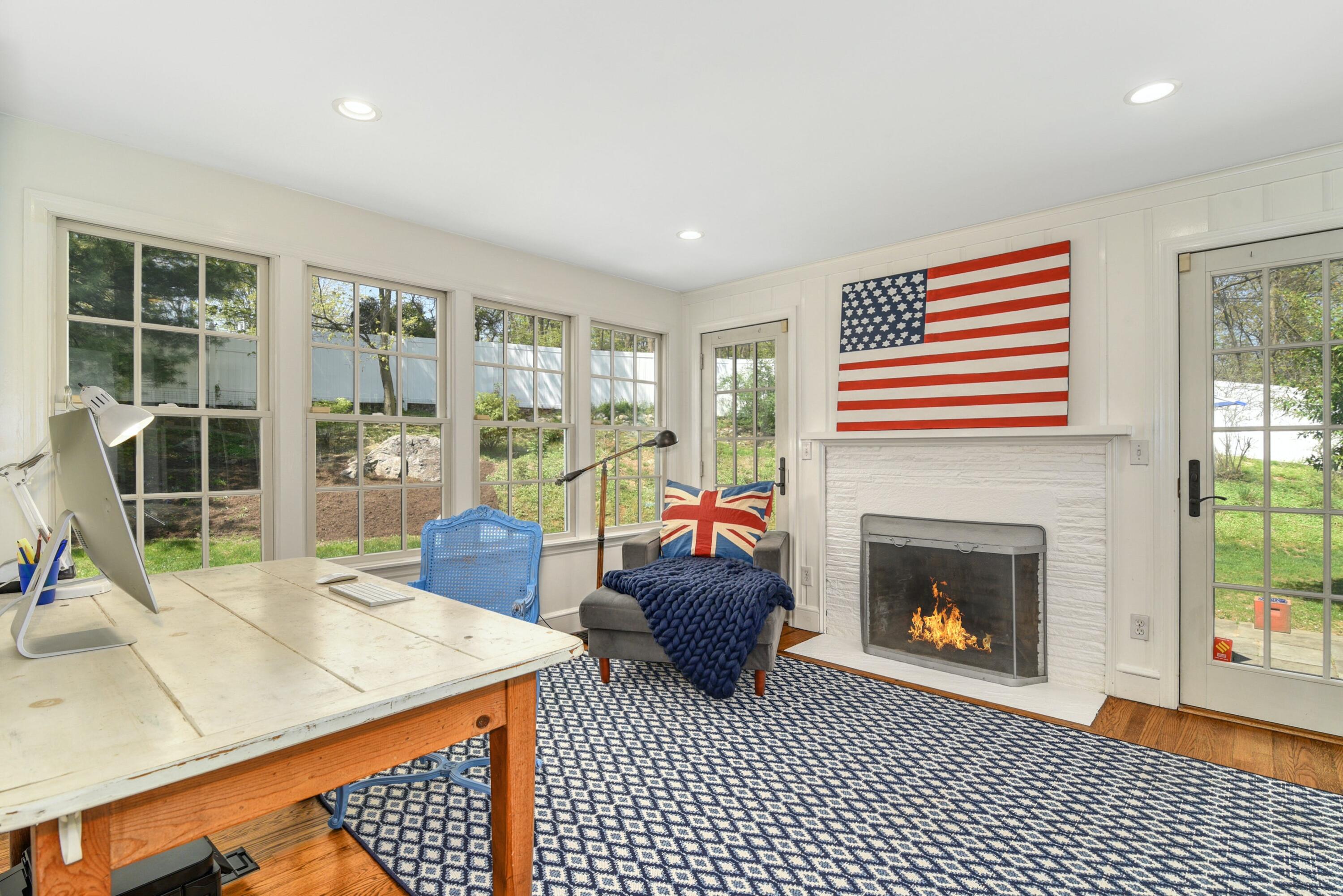 1 Fairmead Road Darien, CT 06820 - Photo 17 of 40 a living room with furniture a floor to ceiling window and a fireplace