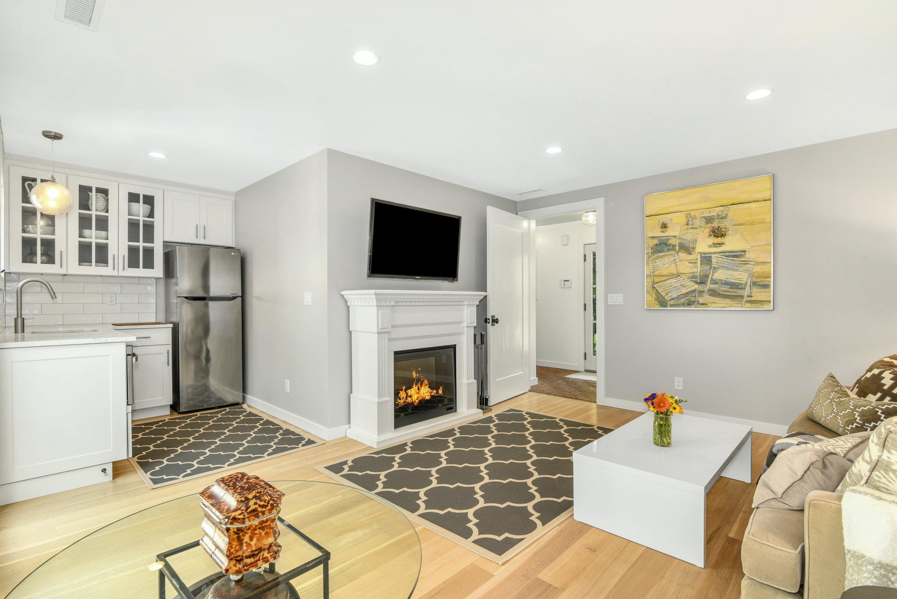 1 Fairmead Road Darien, CT 06820 - Photo 22 of 40 a living room with furniture a flat screen tv and a fireplace