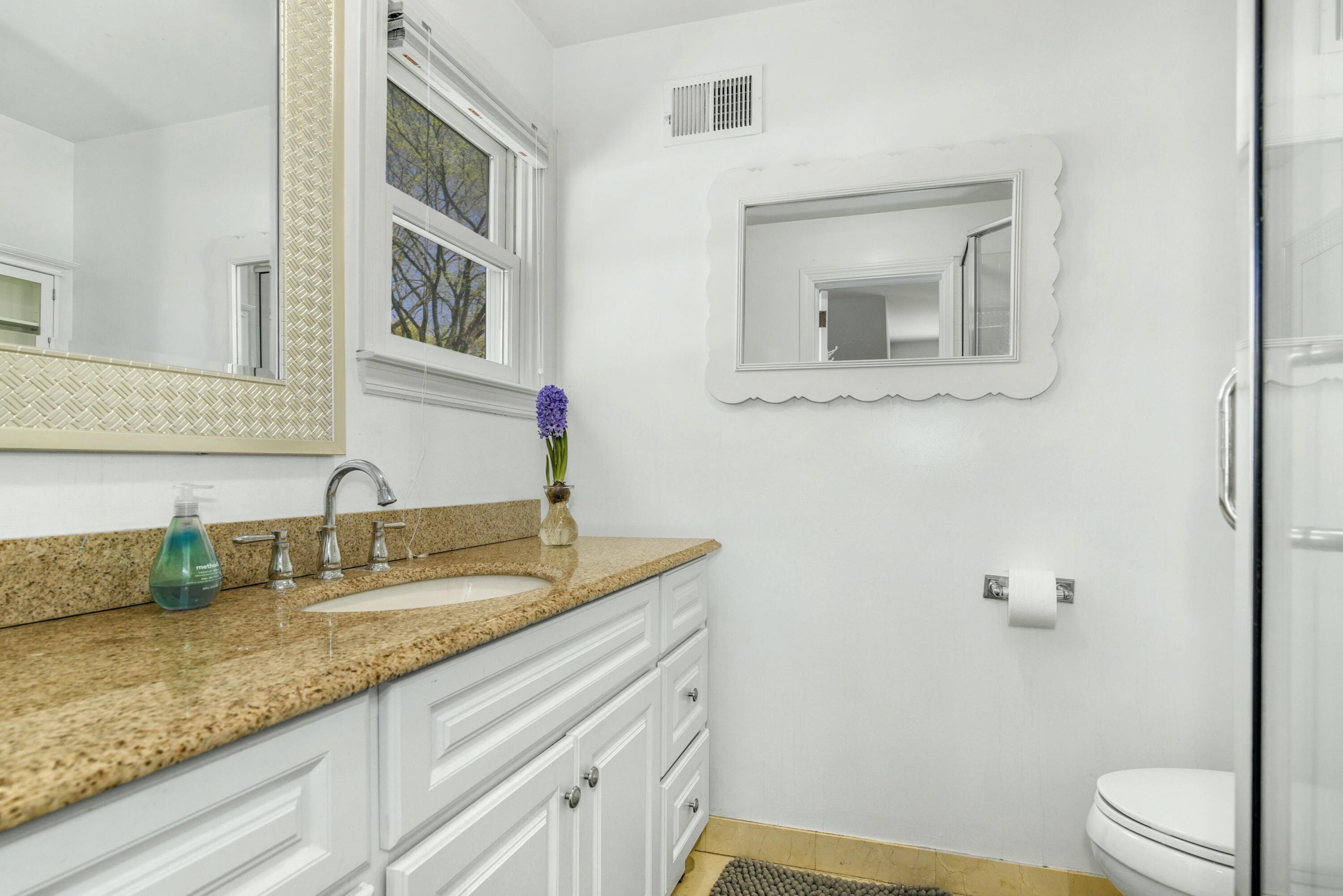 1 Fairmead Road Darien, CT 06820 - Photo 29 of 40 a bathroom with a granite countertop sink vanity mirror and toilet