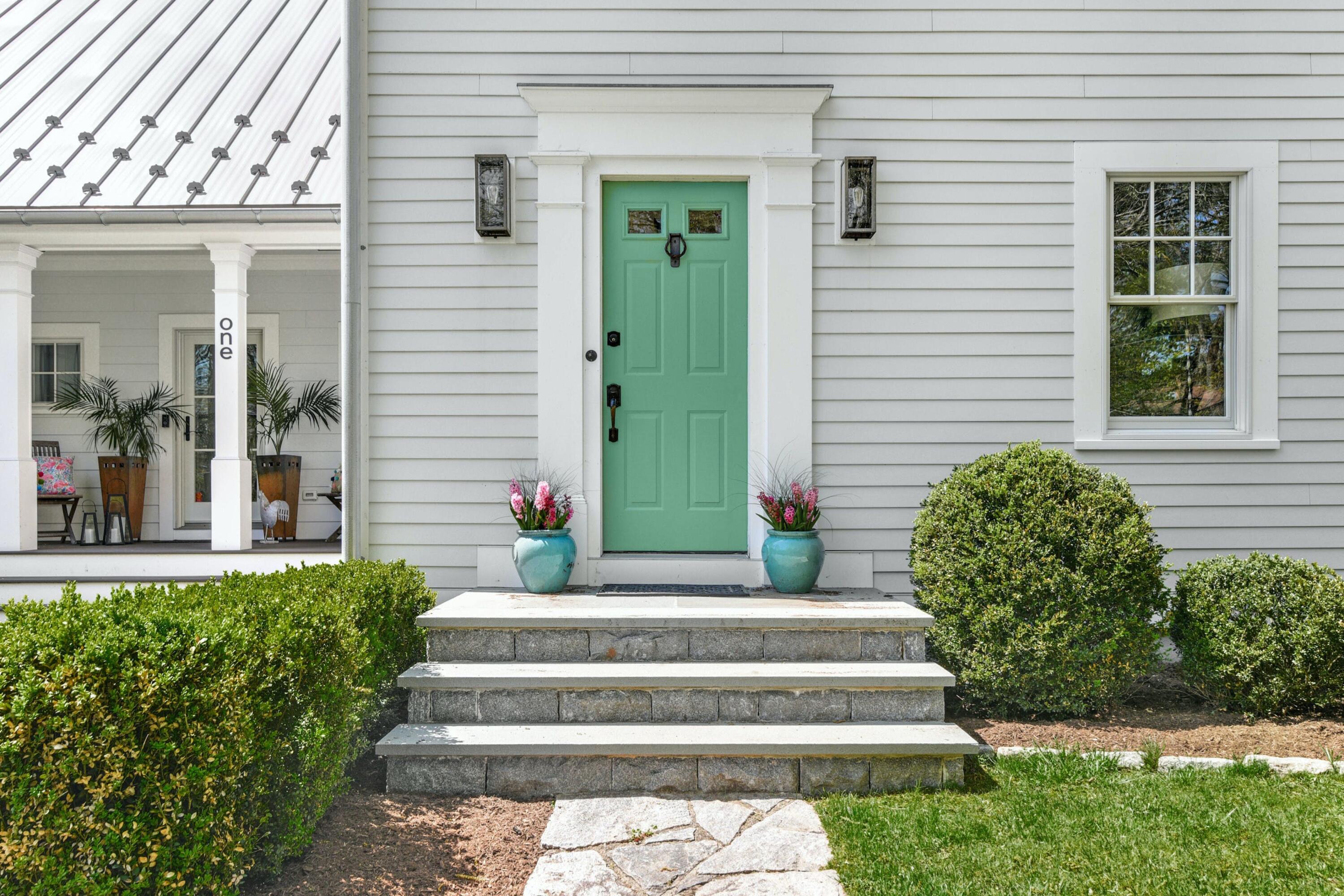 1 Fairmead Road Darien, CT 06820 - Photo 3 of 40 a front view of a house with potted plants