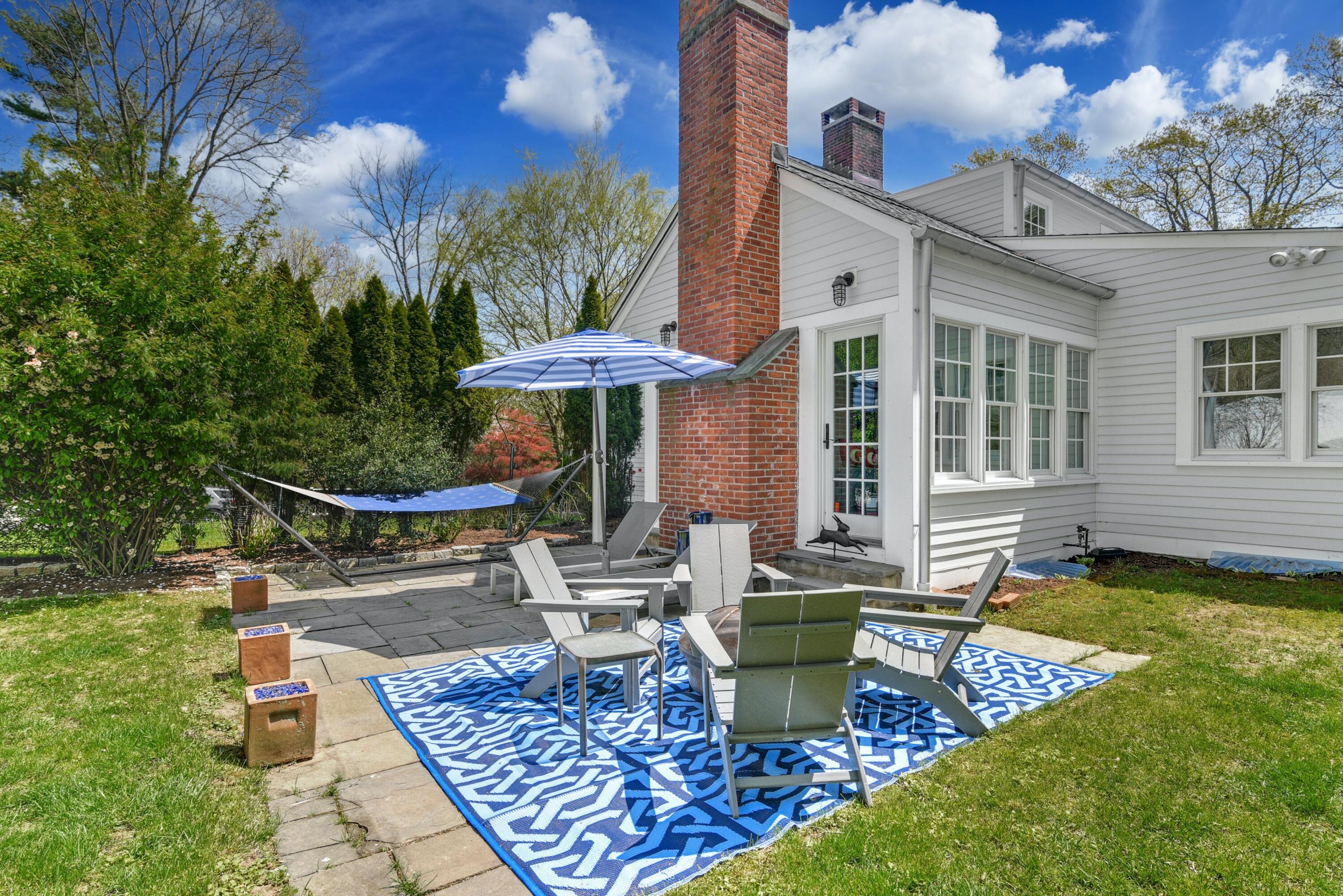 1 Fairmead Road Darien, CT 06820 - Photo 36 of 40 a view of a house with backyard sitting area and swimming pool