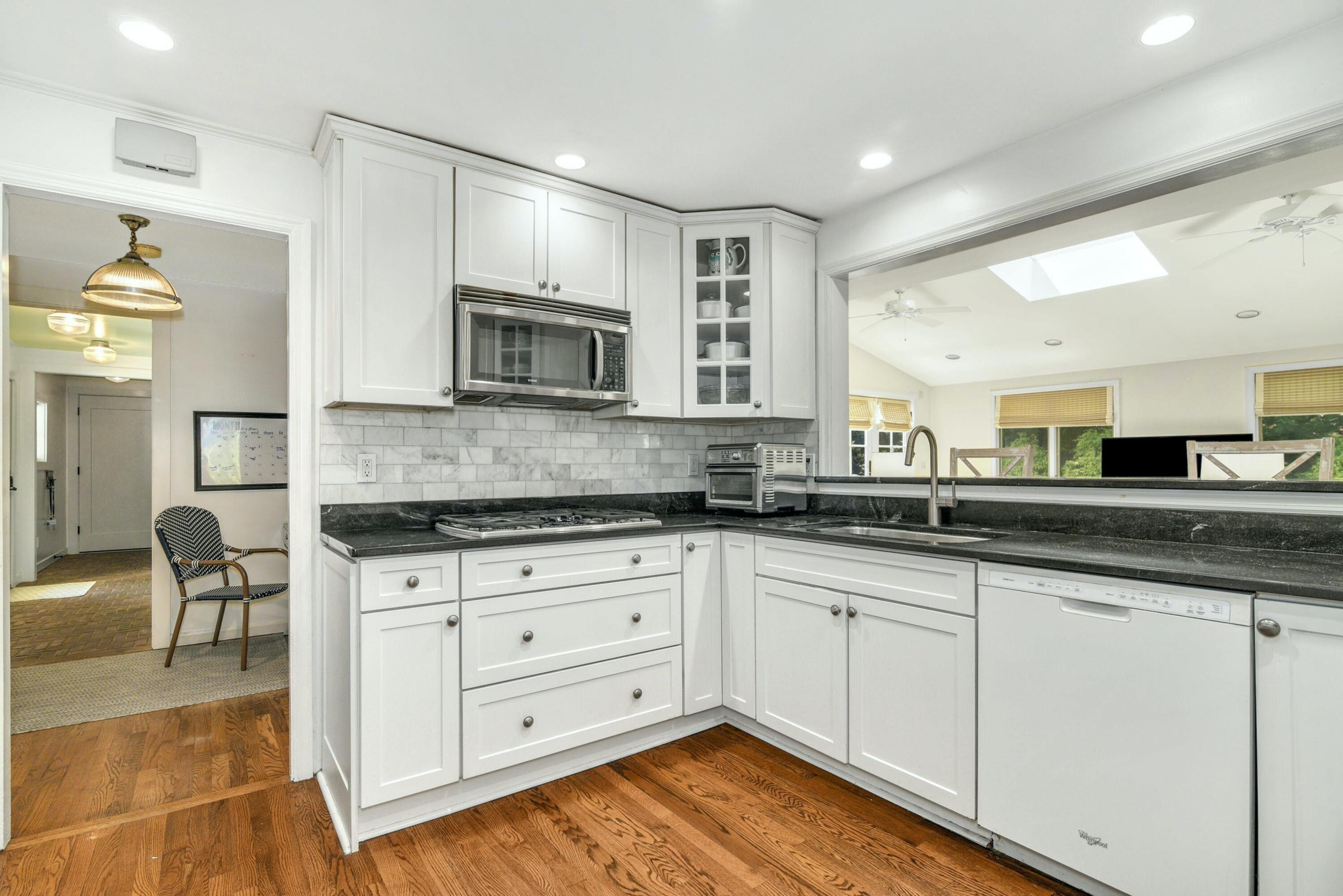 1 Fairmead Road Darien, CT 06820 - Photo 8 of 40 a kitchen with granite countertop a stove a sink and a microwave