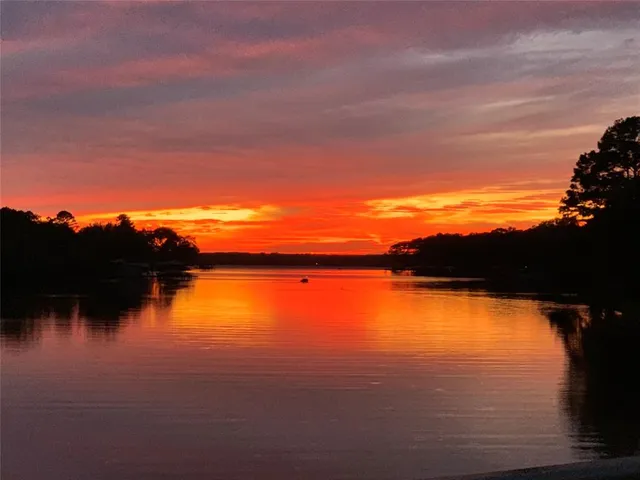 a view of lake with sunset