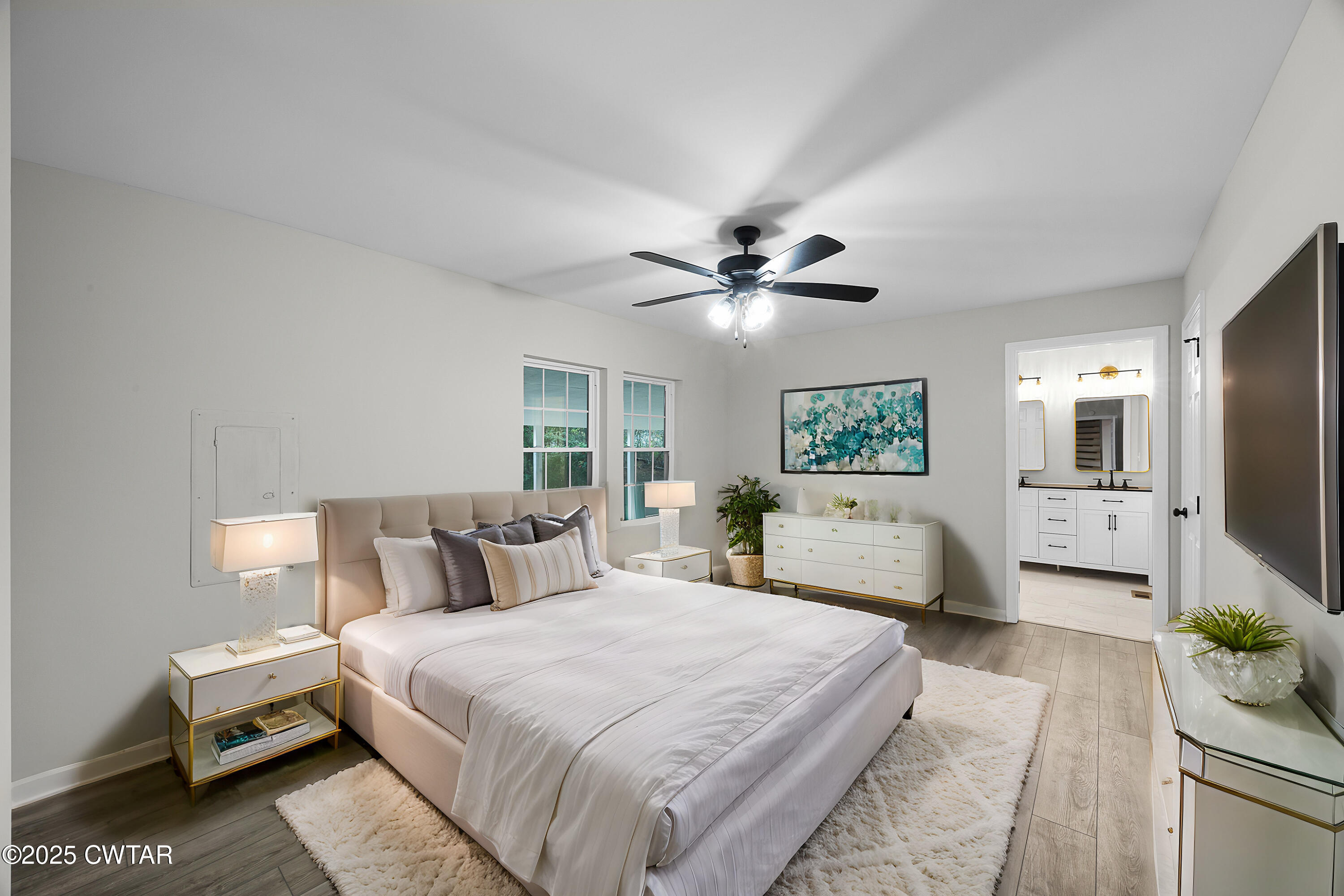 144 McLeary Road Jackson, TN 38305 - Photo 11 of 23 a bedroom with a large bed and a chandelier