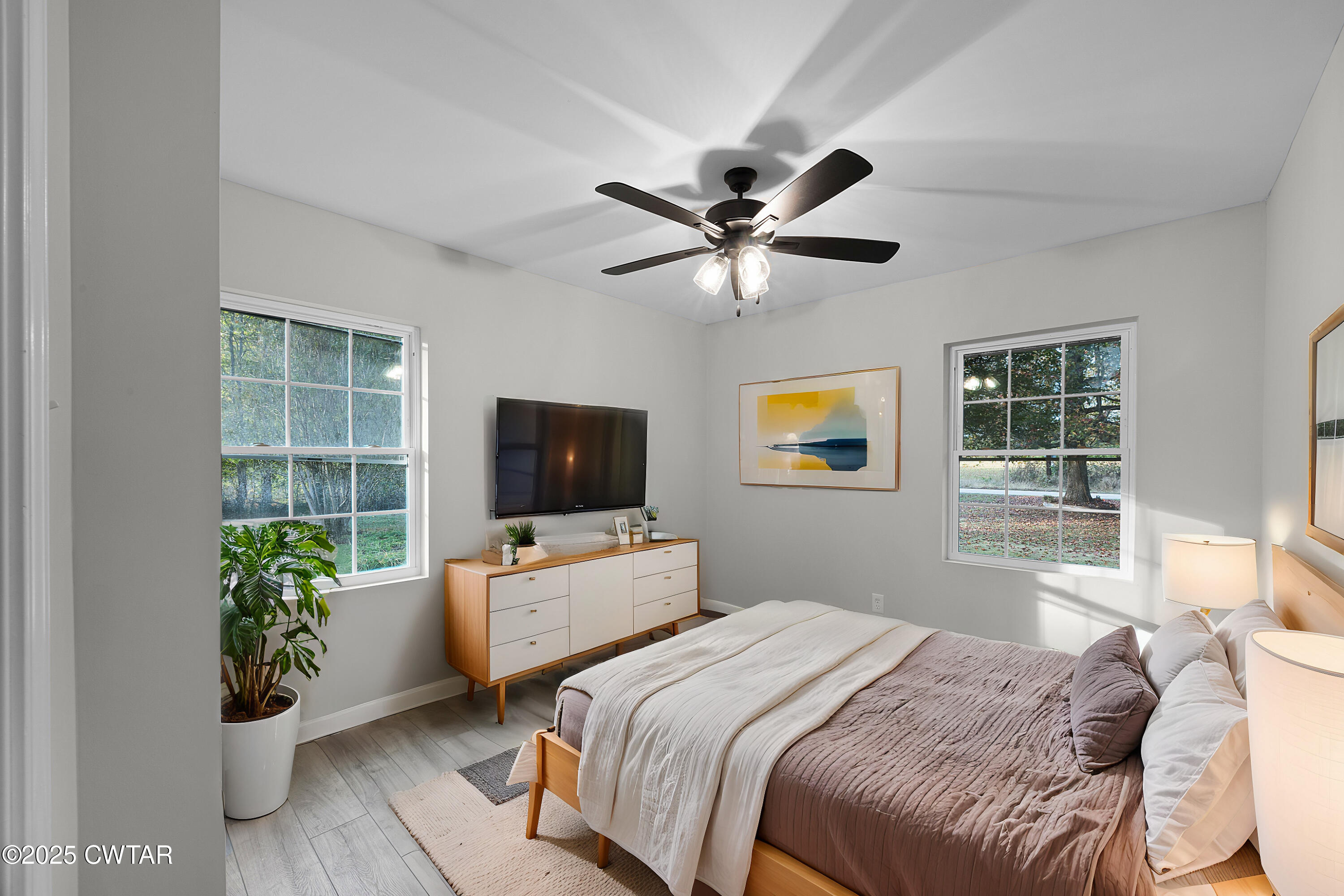 144 McLeary Road Jackson, TN 38305 - Photo 13 of 23 a bedroom with a balcony a bed and a flat screen tv