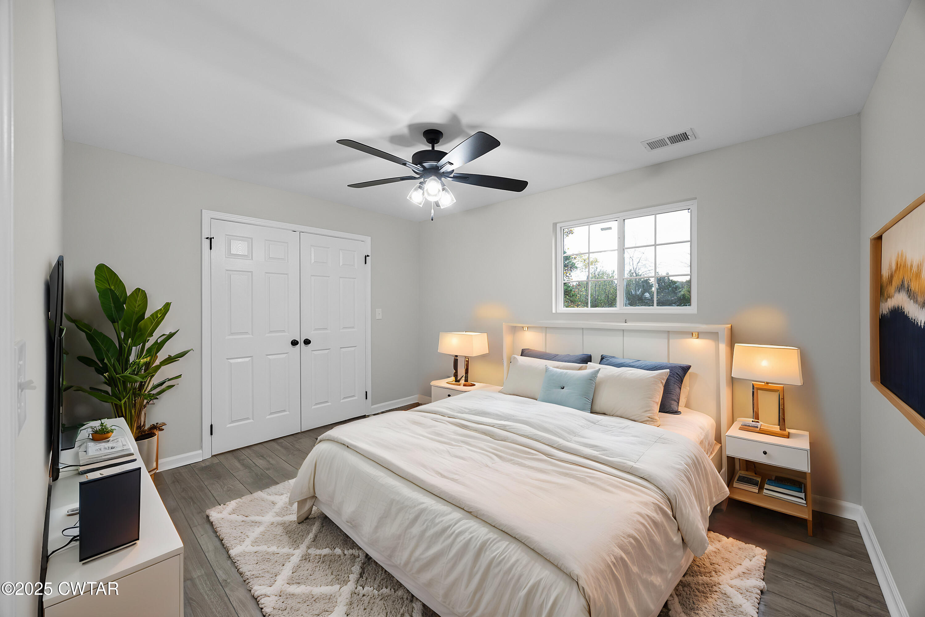 144 McLeary Road Jackson, TN 38305 - Photo 17 of 23 a bedroom with a bed and a chandelier