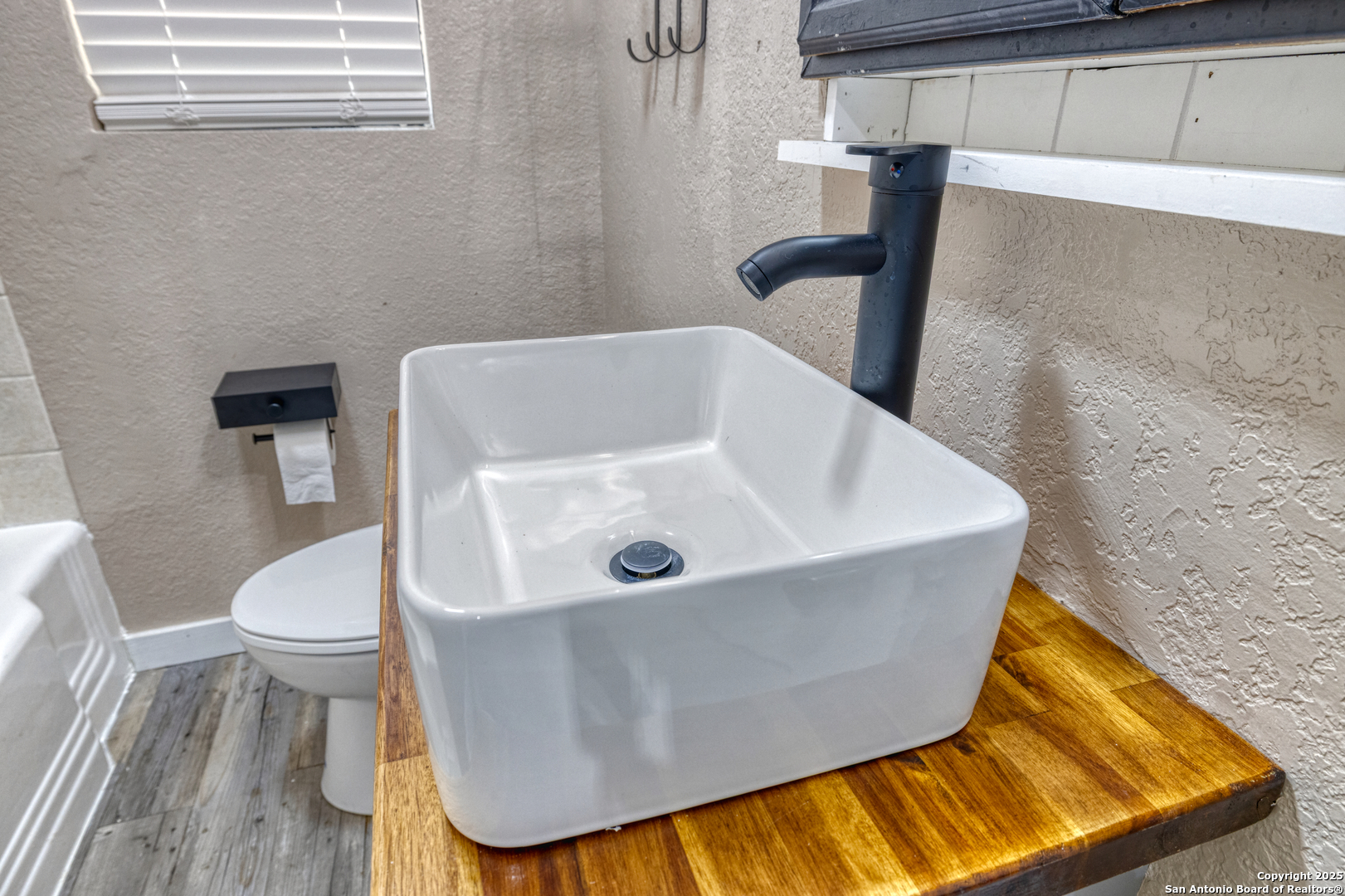 829 Maple Street Uvalde, TX 78801 - Photo 16 of 33 a bathroom with a sink and a toilet