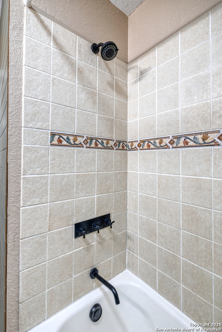 829 Maple Street Uvalde, TX 78801 - Photo 17 of 33 a bathroom with a shower