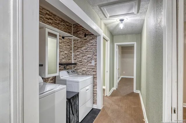 a view of a hallway with washer and dryer