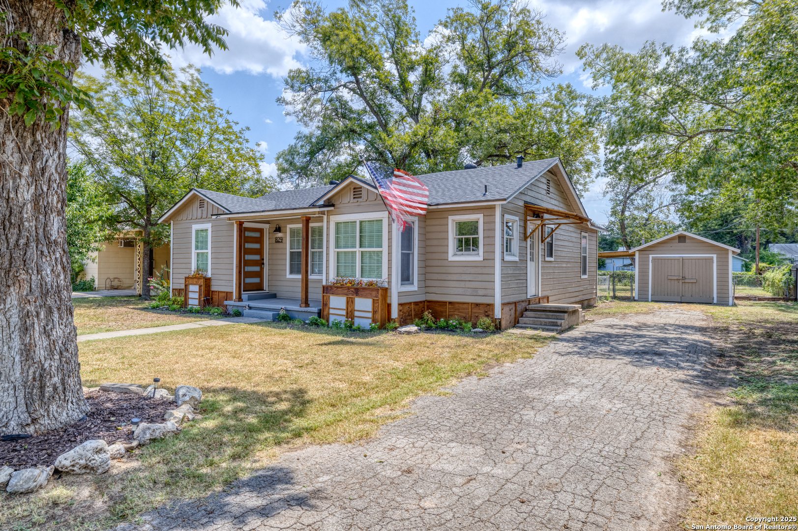 829 Maple Street Uvalde, TX 78801 - Photo 2 of 33 a view of a house with a yard and large tree