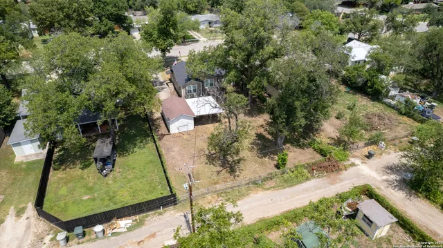an aerial view of a house with a yard