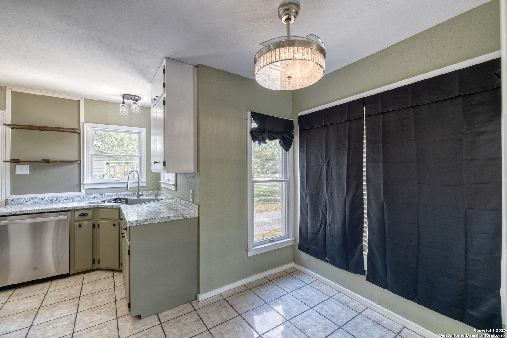 829 Maple Street Uvalde, TX 78801 - Photo 10 of 33 a kitchen with stainless steel appliances granite countertop a refrigerator and a sink
