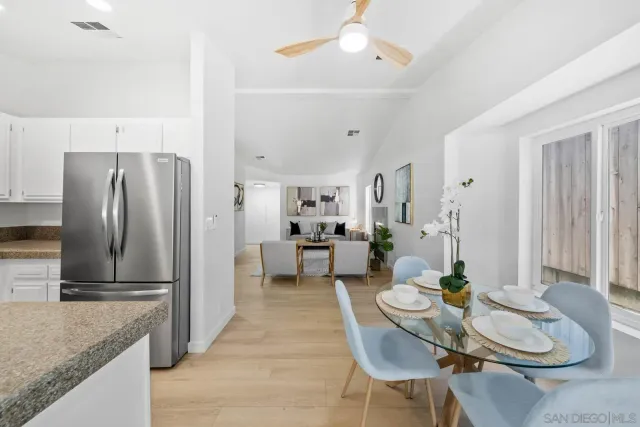 a kitchen with refrigerator cabinets dining table and chairs