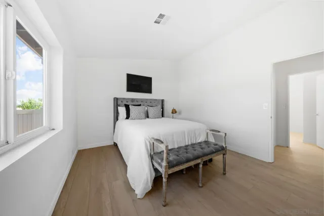 a bedroom with a bed and a night stand