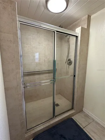 a bathroom with a glass shower door