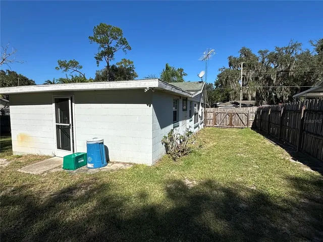 a view of a house with backyard and sitting area