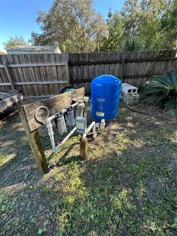 a view of a chair and table in the backyard