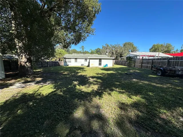 a backyard of a house with a yard and outdoor seating