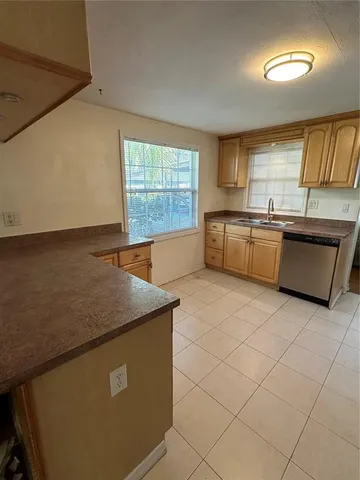 a room with a desk and chairs