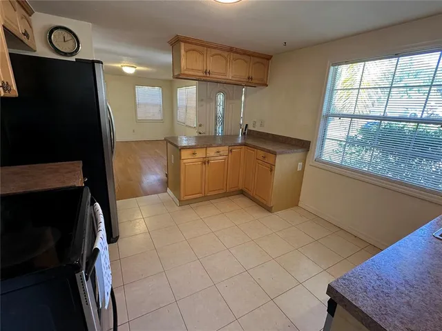 a kitchen with a refrigerator and a stove