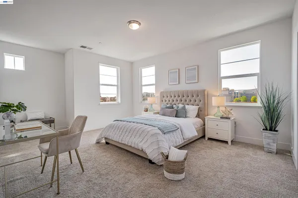 a bedroom with a large bed and a couch