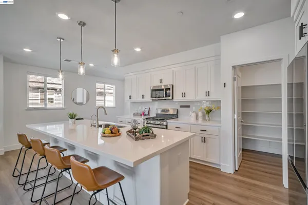 a kitchen with a refrigerator and a white cabinets