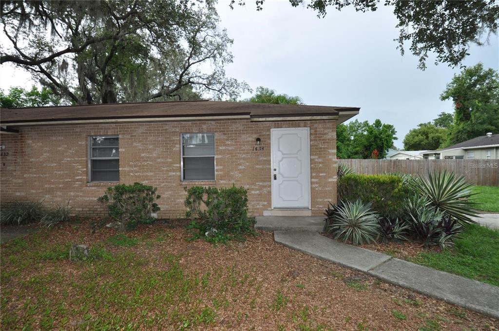 1434 East Fern Road, Unit 1434 Lakeland, FL 33801 - Photo 2 of 13 a front view of a house with a yard