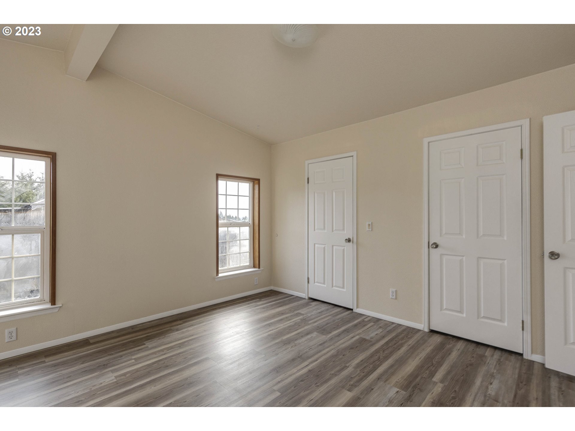 23246 Gooseneck Road Sheridan, OR 97378 - Photo 12 of 27 a view of an empty room with wooden floor and a window