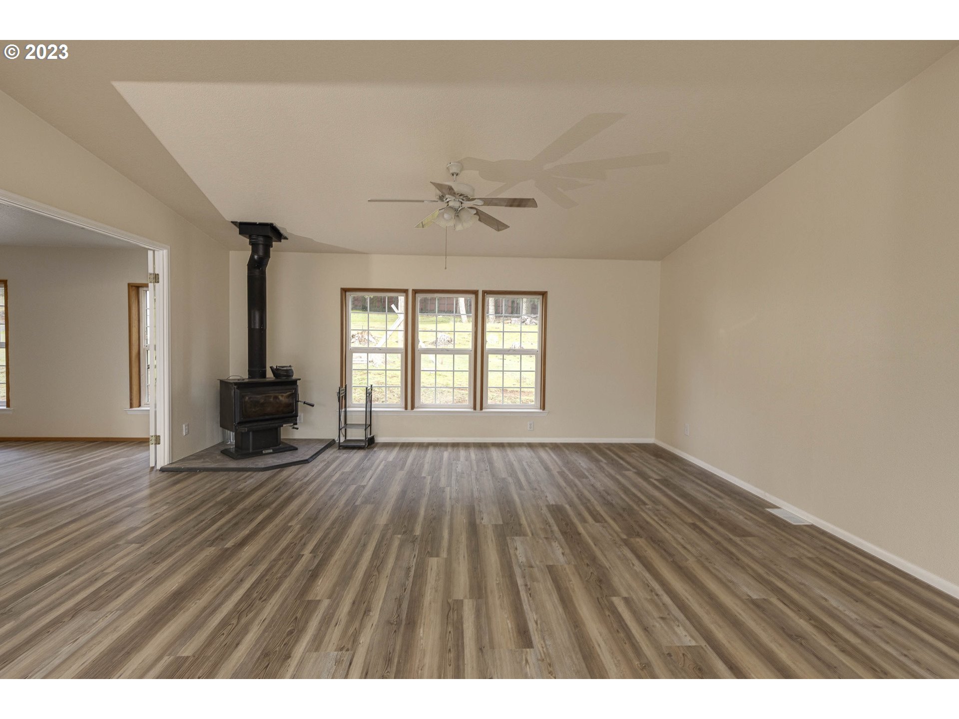 23246 Gooseneck Road Sheridan, OR 97378 - Photo 4 of 27 wooden floor in an empty room with a fireplace