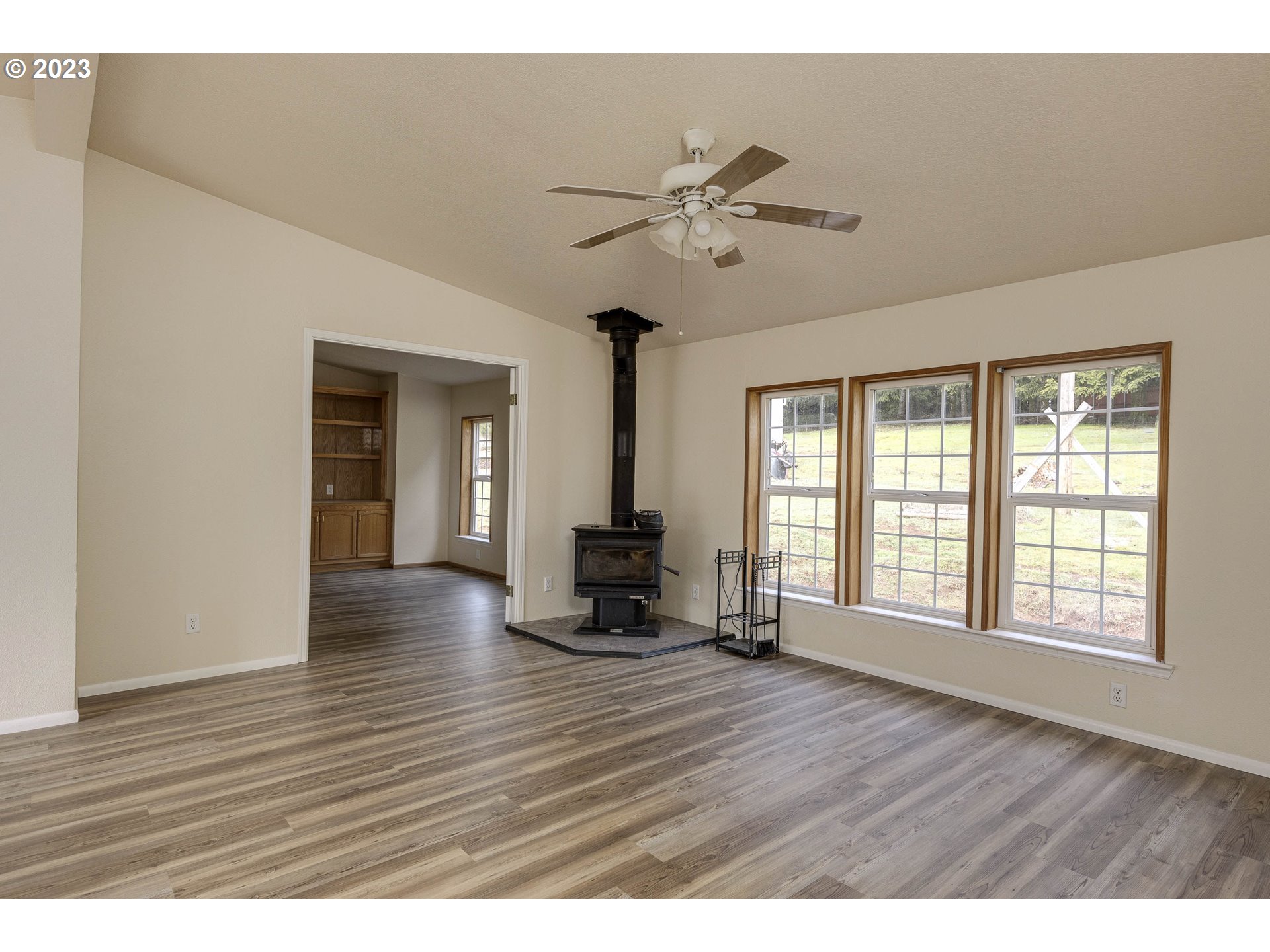 23246 Gooseneck Road Sheridan, OR 97378 - Photo 6 of 27 a view of an empty room with wooden floor and a window