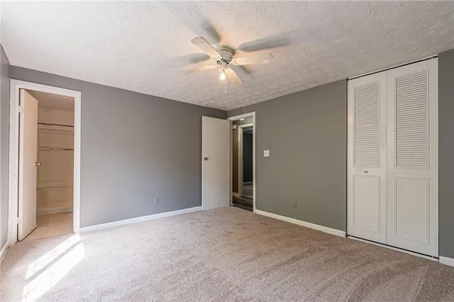 a view of an empty room with a ceiling fan