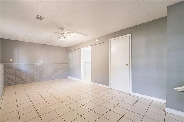 a view of an empty room and a bathroom