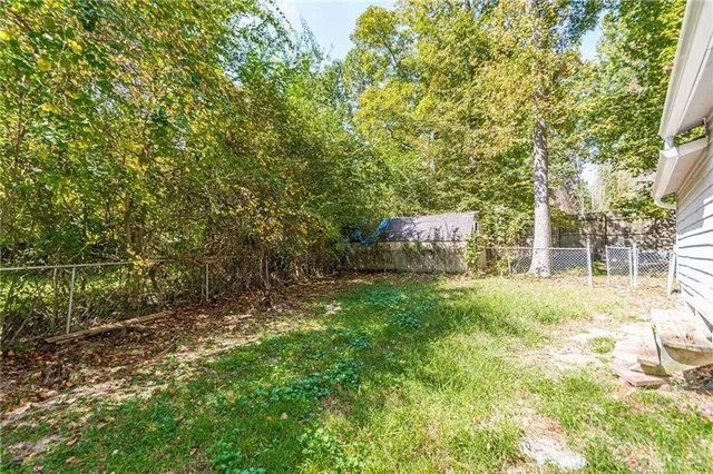 a backyard of a house with lots of green space and fountain