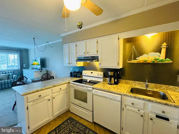 a kitchen with sink cabinets and appliances