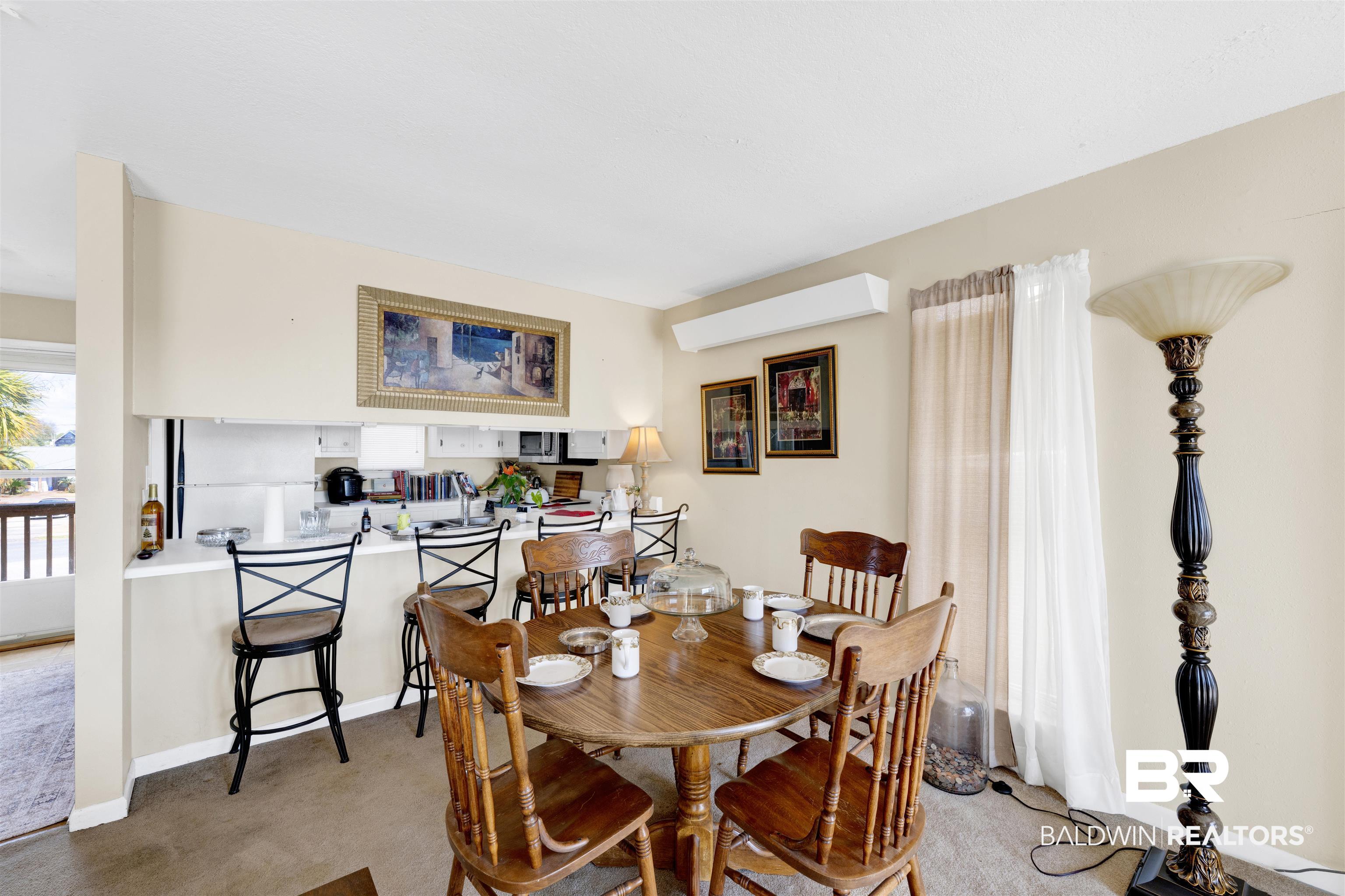 26222 Marina Road Orange Beach, AL 36561 - Photo 18 of 38 Dining area with light colored carpet and baseboards