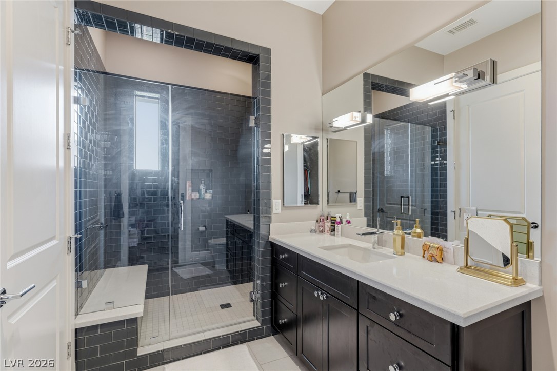 5 Crystal Tree Pass Henderson, NV 89052 - Photo 26 of 67 Sleek vanity with a generous counter space complements the spacious, tiled shower.