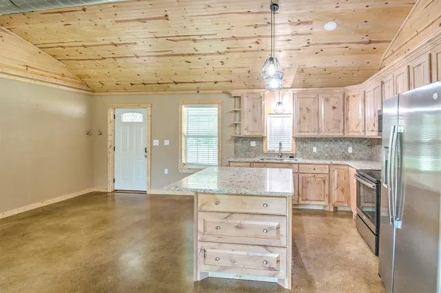 a bathroom with a granite countertop sink and white cabinets
