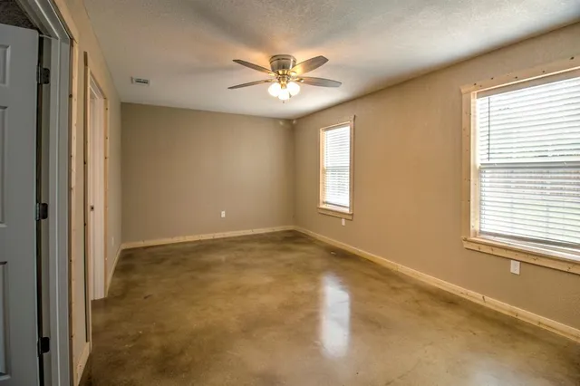 a view of a livingroom with a ceiling fan and window